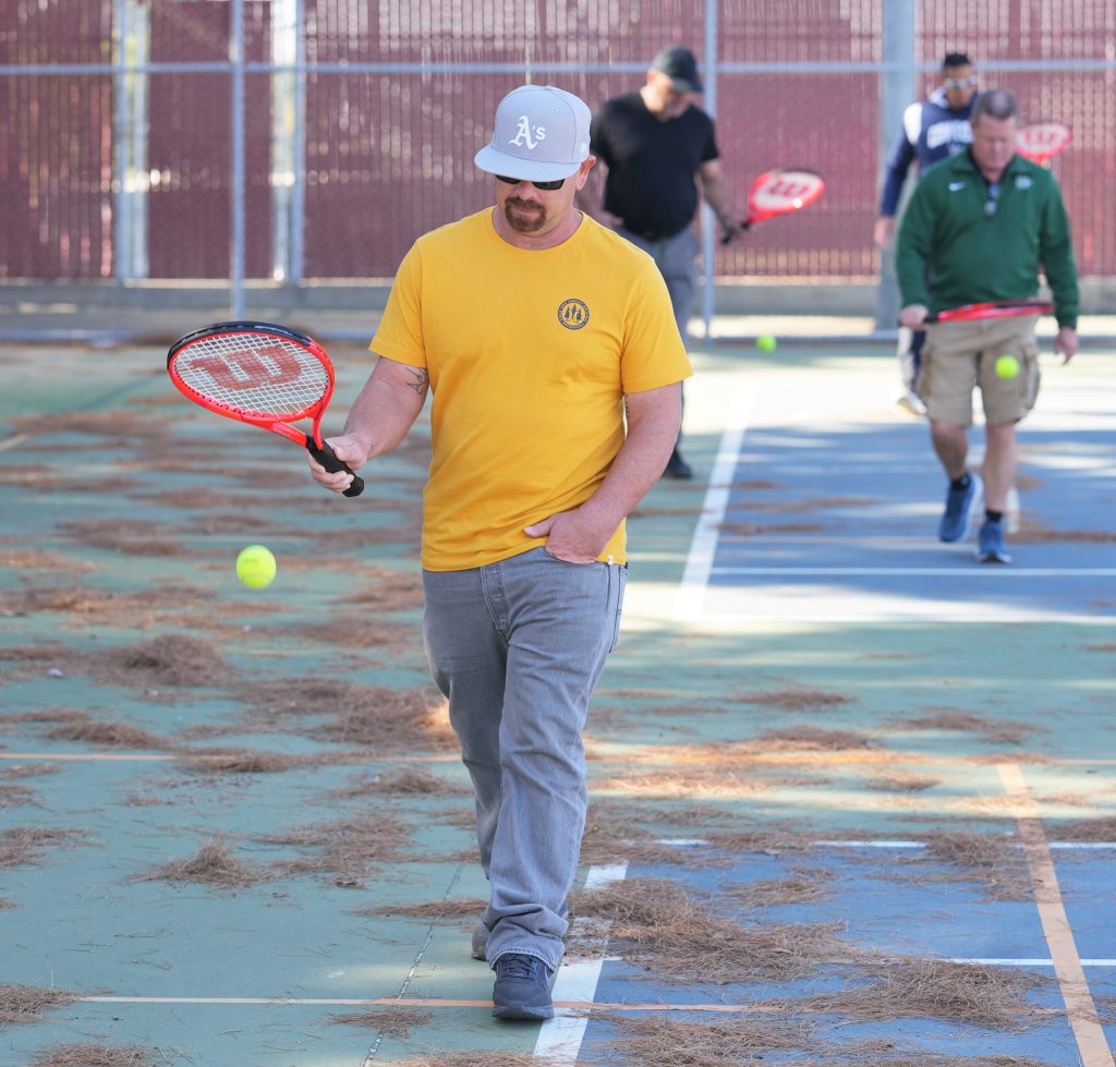 CDCR coaches bounce tennis balls.
