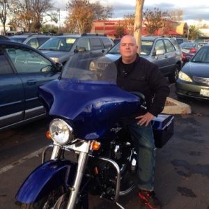 Sitting on a motorcycle is Matthew Dyer.