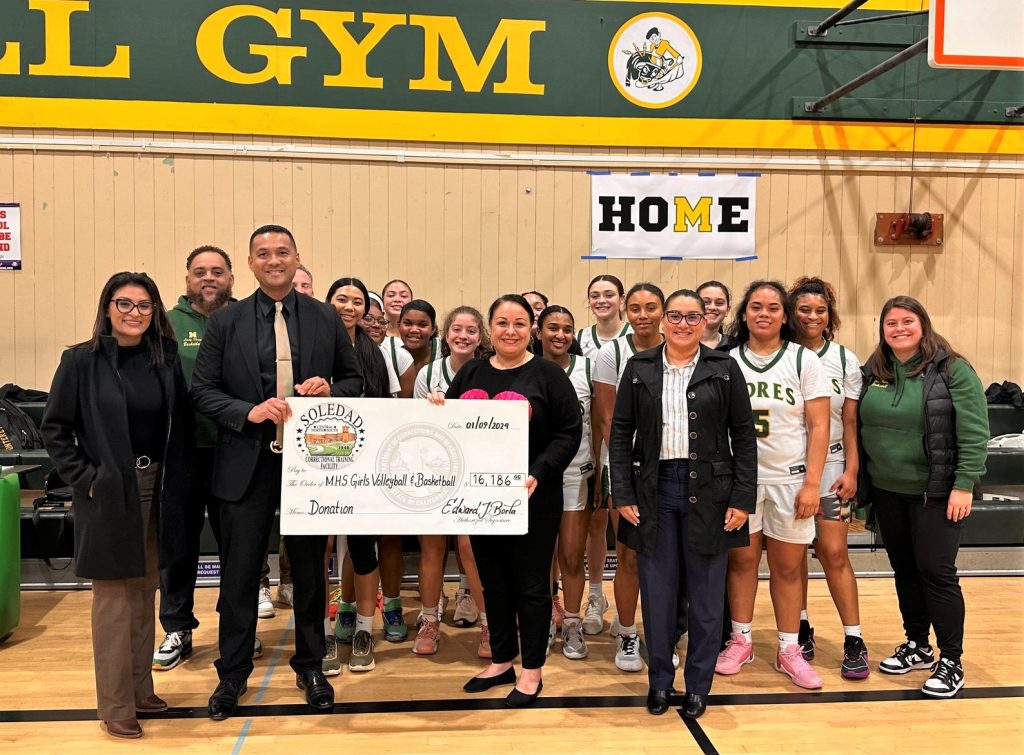 Correctional Training Facility staff present a donation to youth sports from the Fathers Behind Bars program.