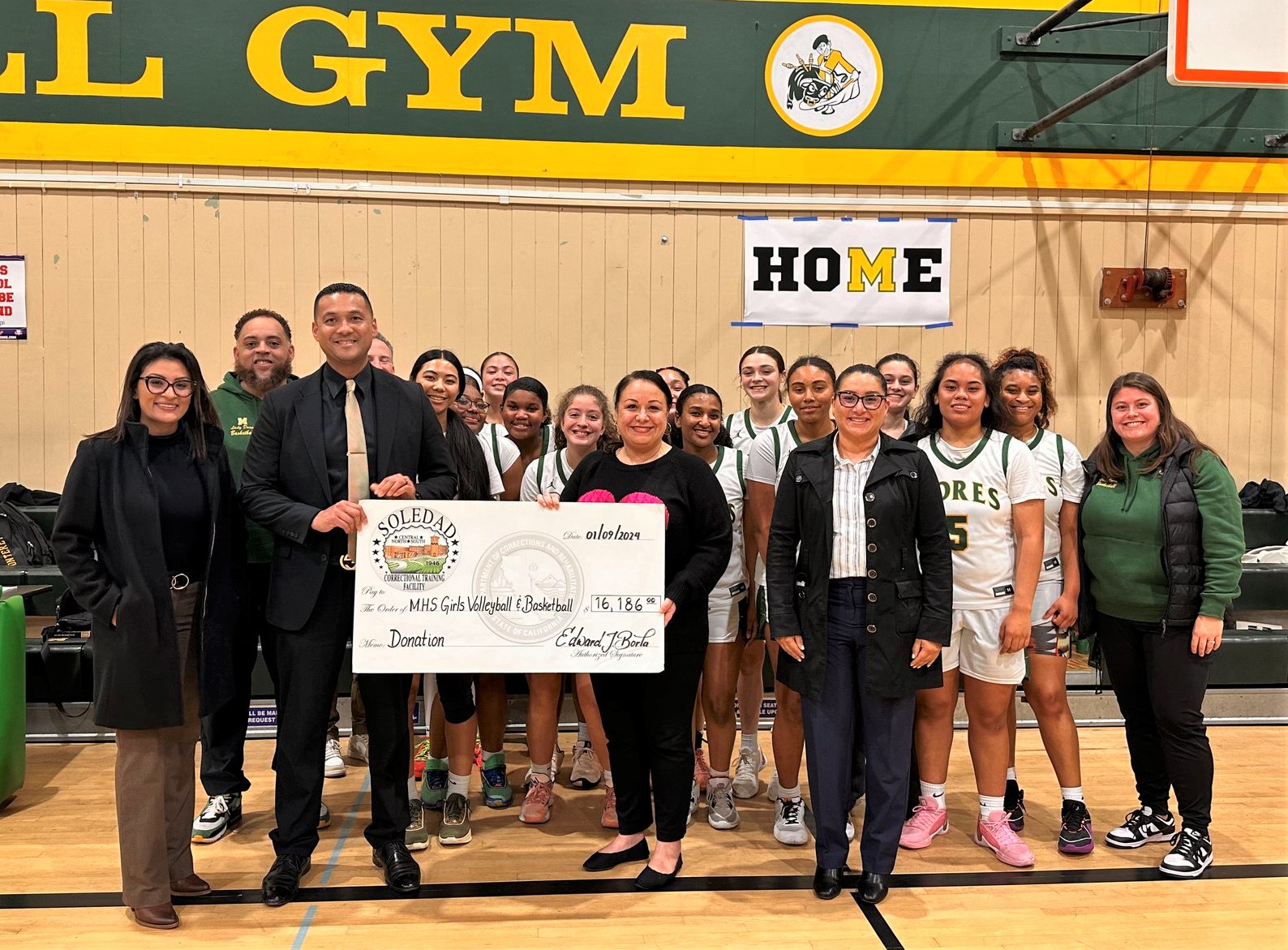 Correctional Training Facility staff present a donation to youth sports from the Fathers Behind Bars program.