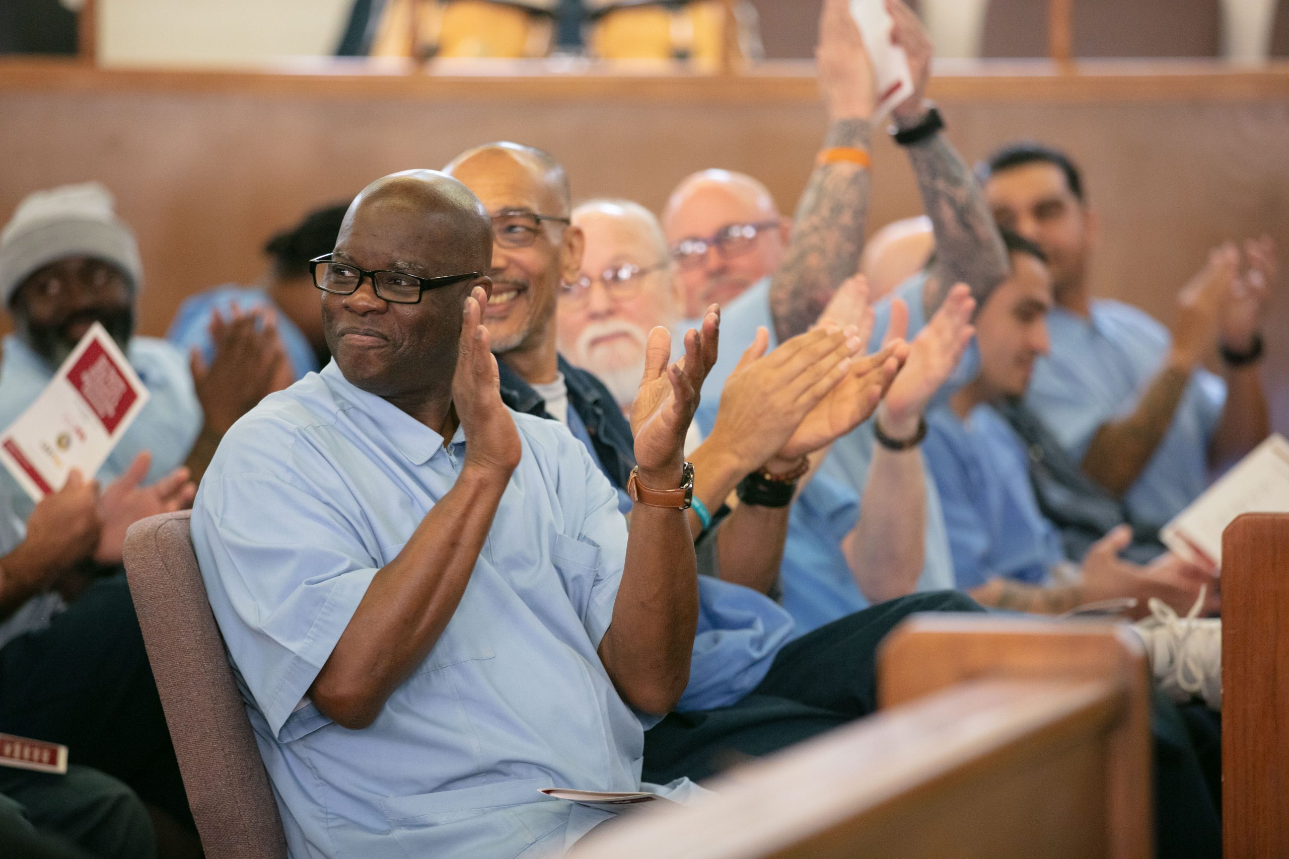 Incarcerated people cheer on those who graduated CALPIA programs at San Quentin.
