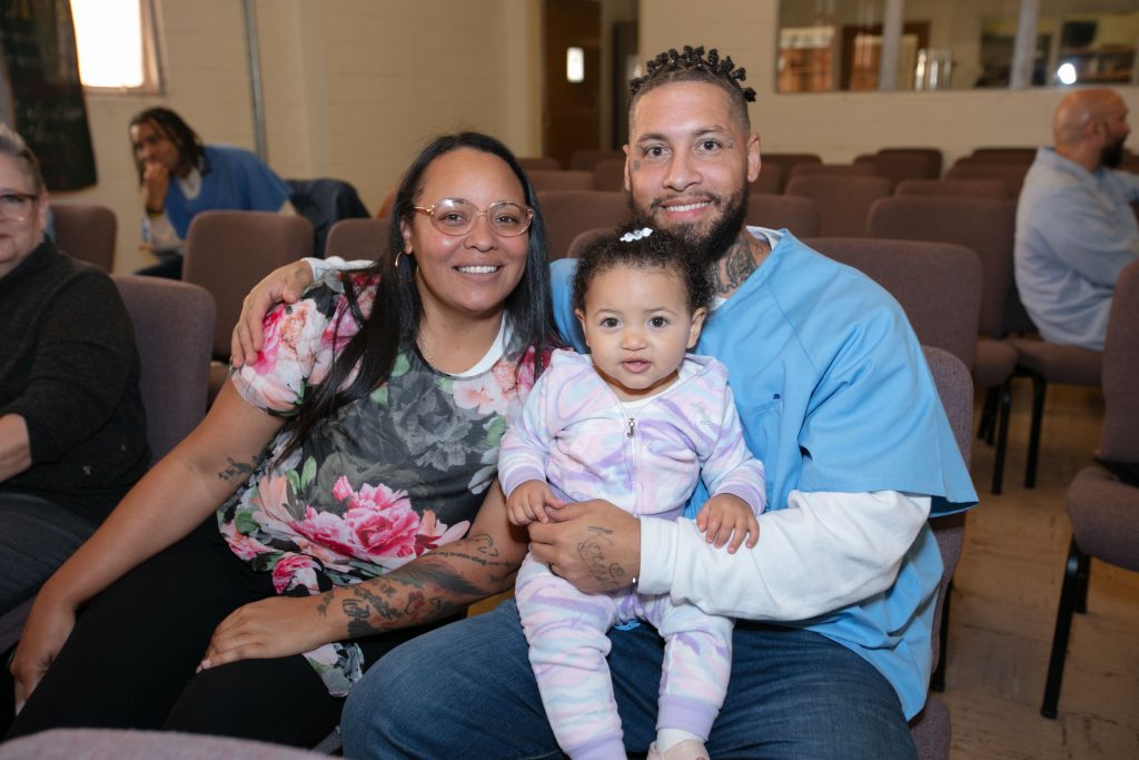 A CALPIA graduate and a woman with a baby in San Quentin Rehabilitation Center.