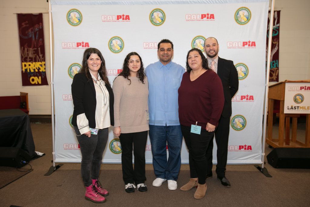 An incarcerated graduate along with instructors and his family.