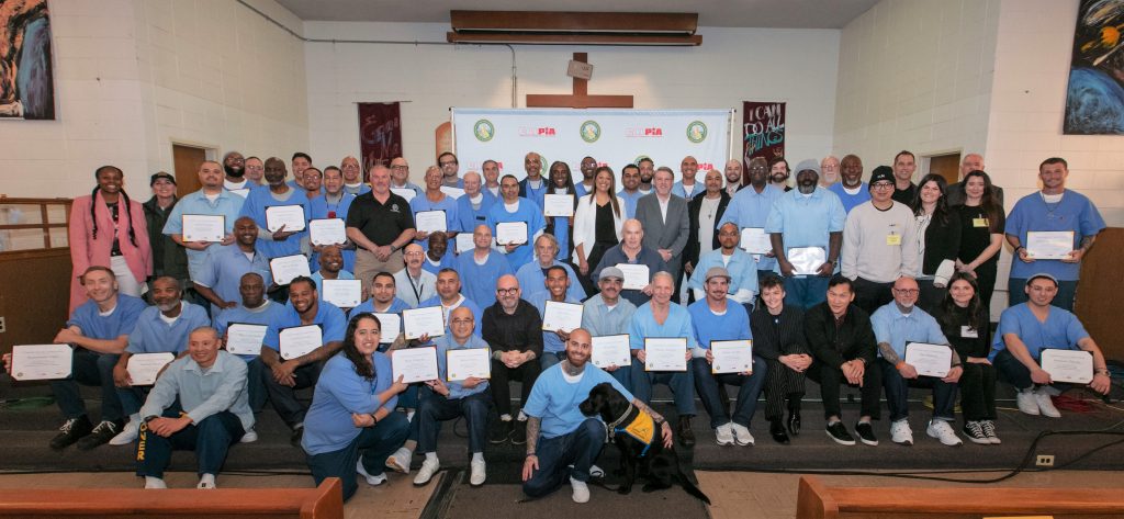 Group photo of graduates and staff at San Quentin.