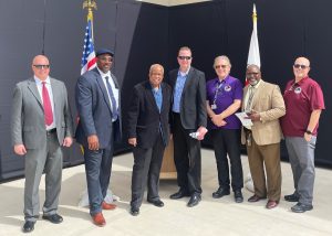 Group of current and retired officials on a stage at Ironwood State Prison.