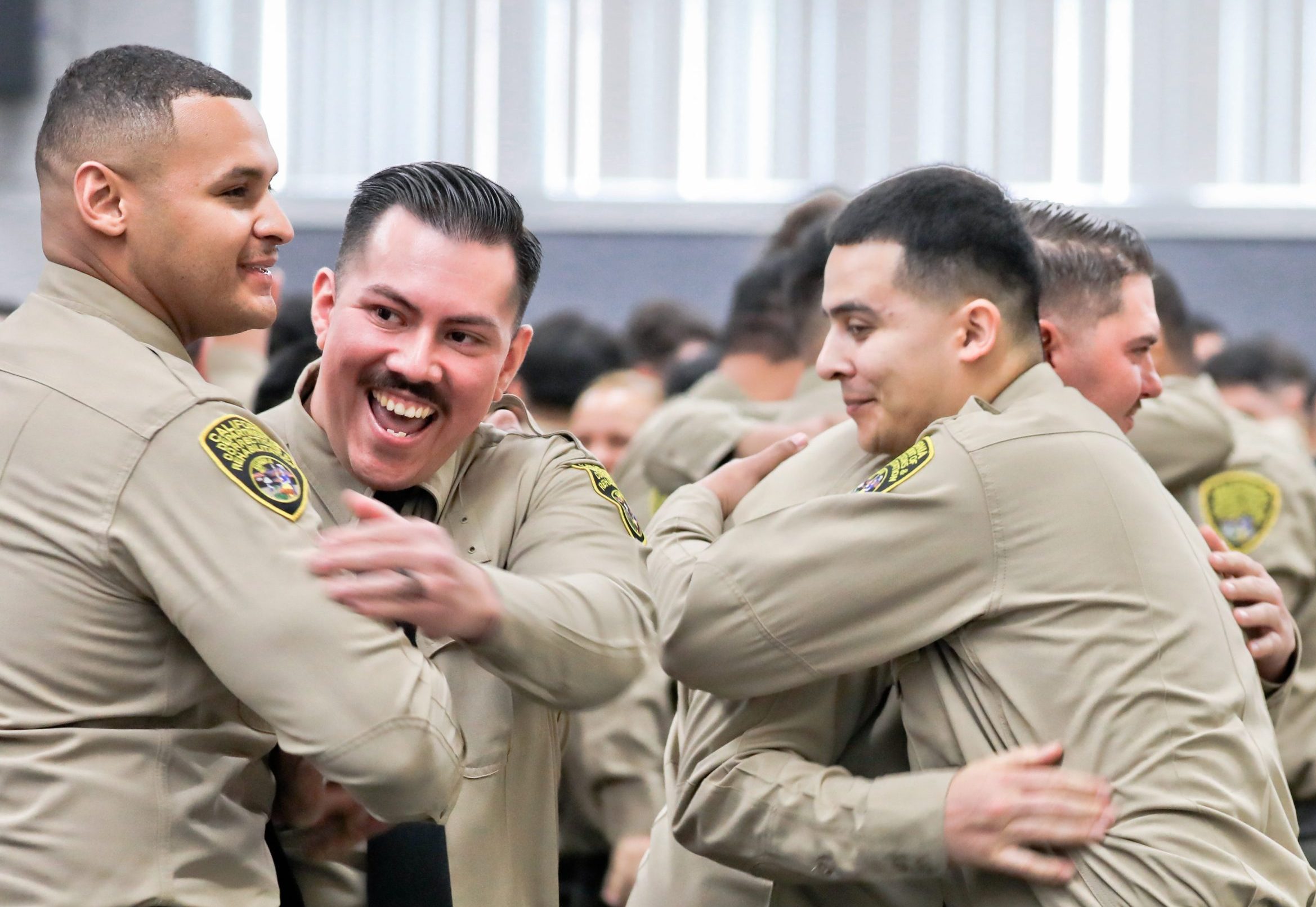 New sworn correctional officers celebrate their graduation.