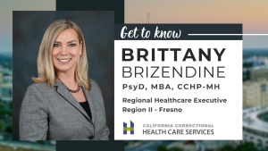 Smiling blonde woman in gray suit on a blue background, Brittany Brizendine, PsyD, MBA, CCHP-MH, Regional Health Care Executive of Region II, Fresno for California Correctional Health Care Services.