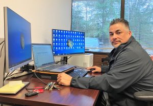 Parole supervisor sits at a desk in the Auburn parole office.
