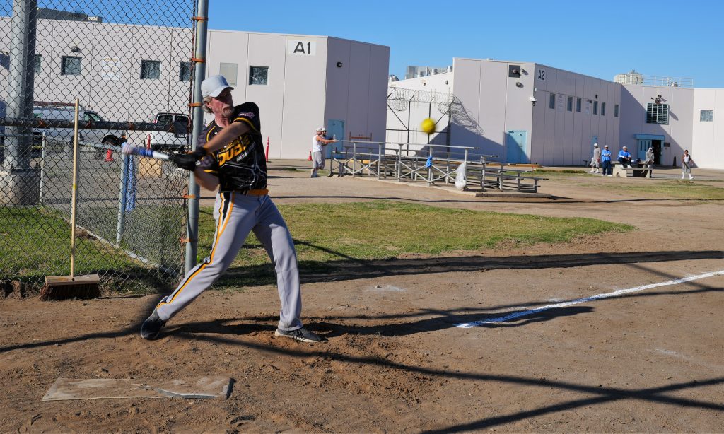 A volunteer demonstrates a batting technique.