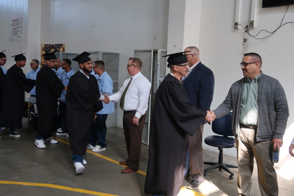 CEN ISUDT graduates shaking hands with staff