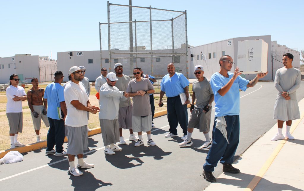 A group of incarcerated people and a box.