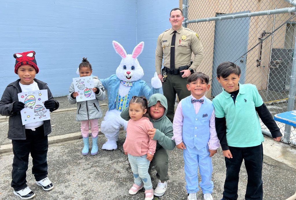 Children wearing Easter clothing visit with Mr. Bunny at CIM.