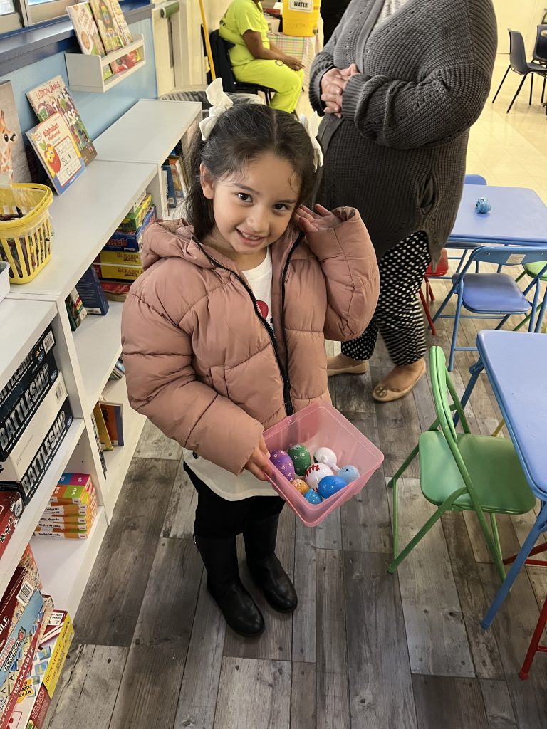 Girl holds an Easter basket.