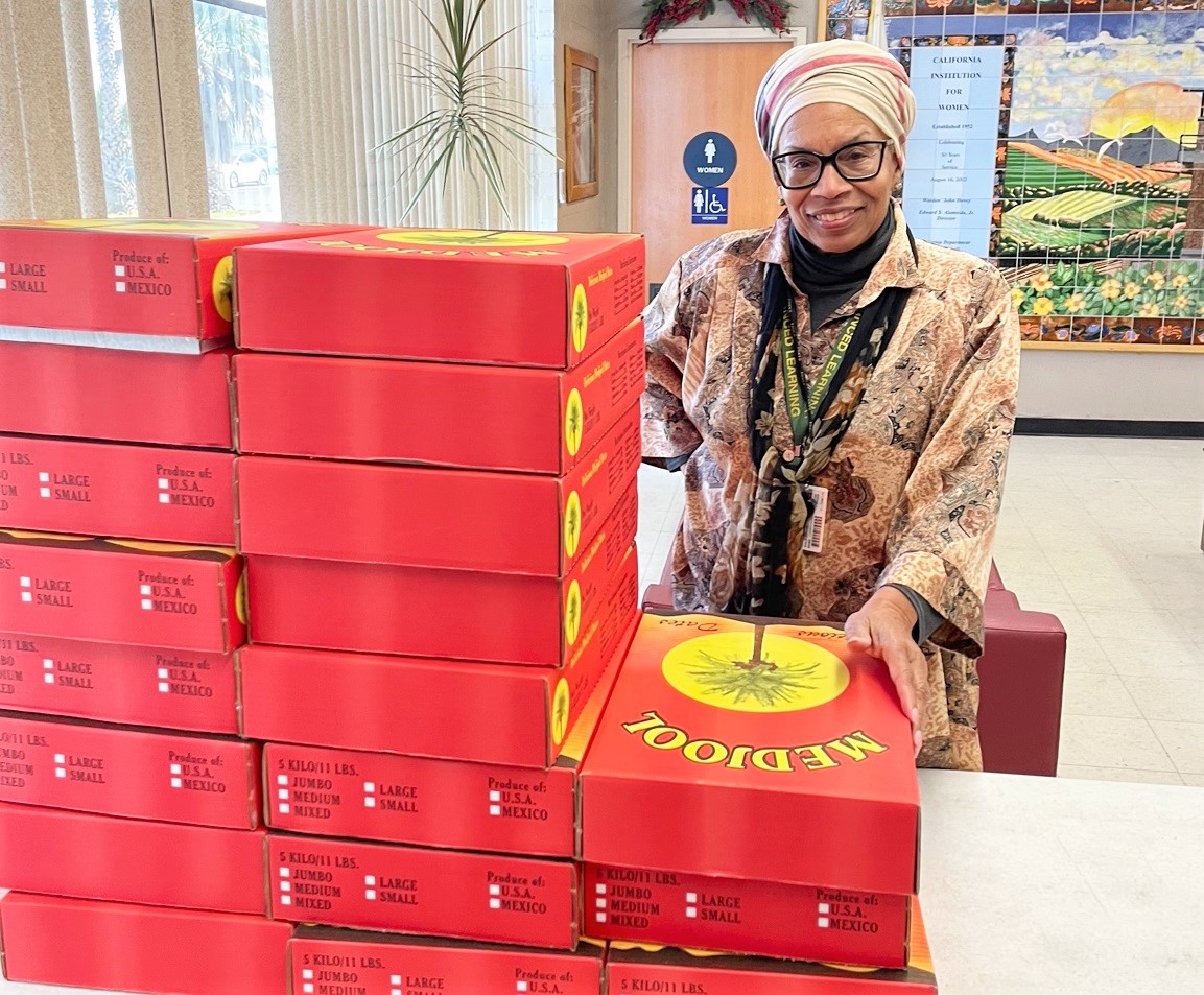 A Muslim Imam chaplain with boxes of dates for Ramadan at California Institution for Women, also known as CIW.