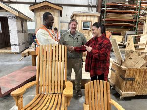 Incarcerated woodworker and his instructor present a rocking chair to the new warden at CSP-Corcoran.