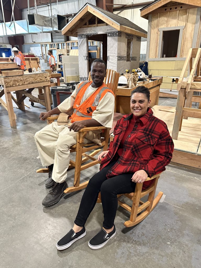 A prison warden and an incarcerated woodworker sit in rocking chairs at CSP-Corcoran.