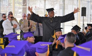 An education program graduate at CRC holds.