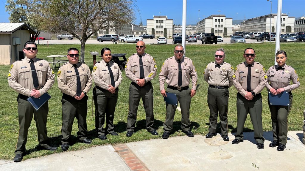 Eight sergeants standing together for a group photo at a prison.