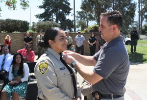 CTF promotion ceremony for sergeant with warden pinning chevrons to collar.