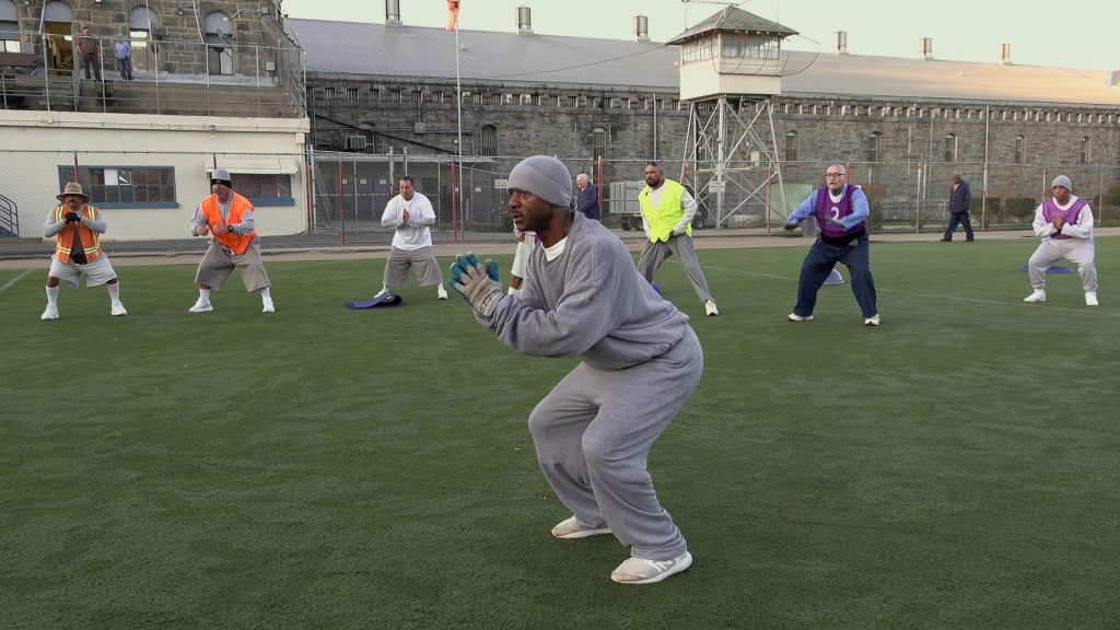 Squat exercises in a prison yard helps older incarcerated people.