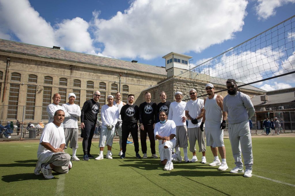 A group photo of volunteers with incarcerated people at Folsom prison.