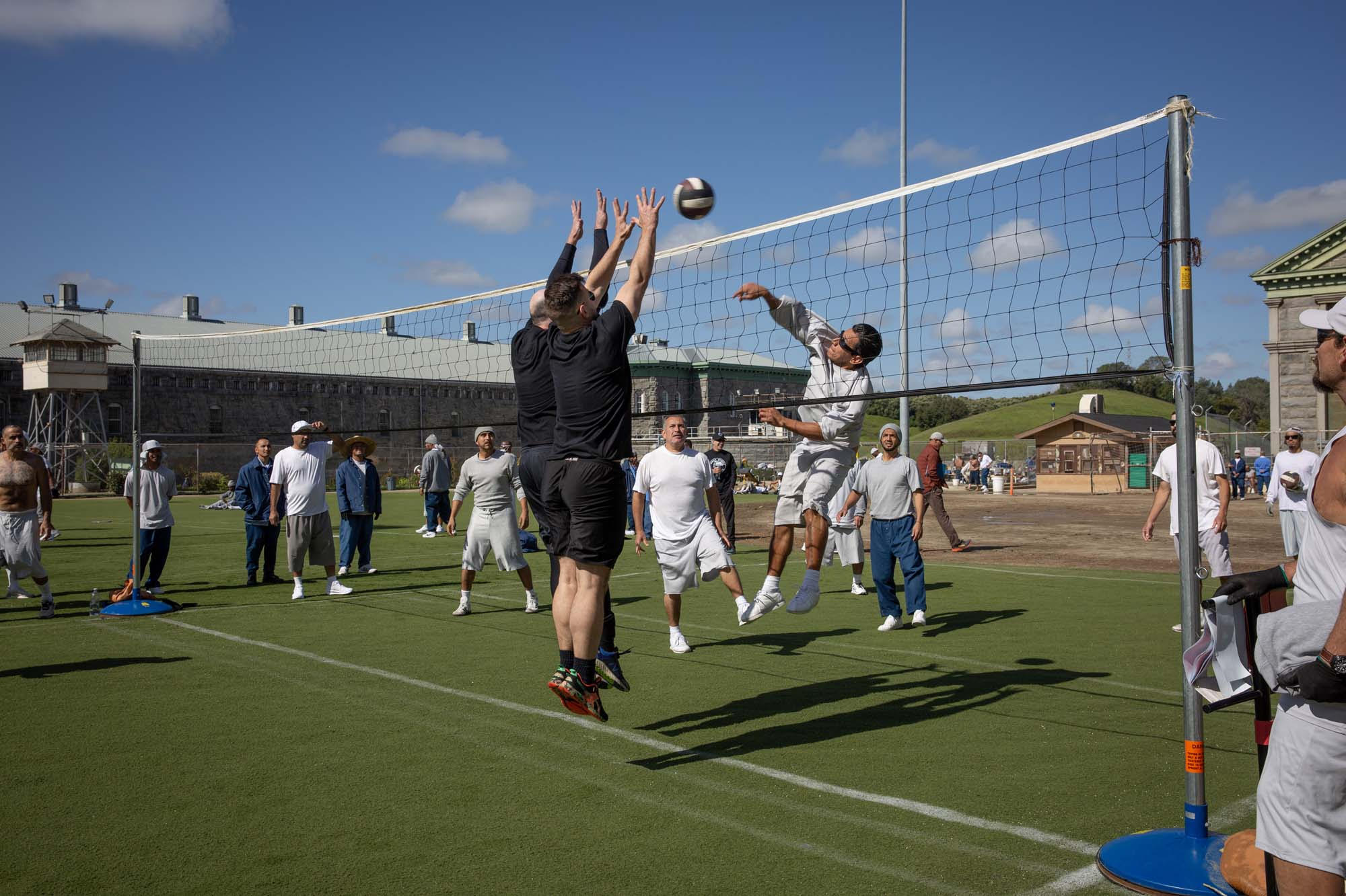 Volunteers play volleyball with the population at Folsom State Prison.