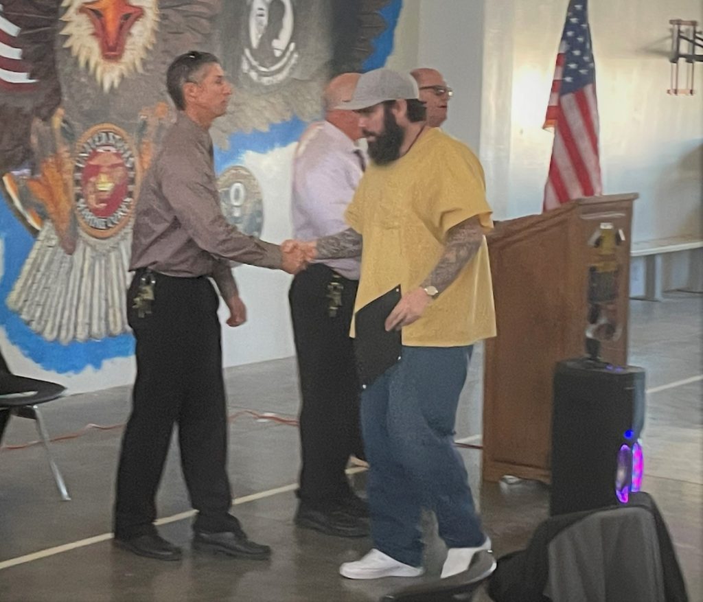 ISUDT graduate at HDSP shakes hands with staff