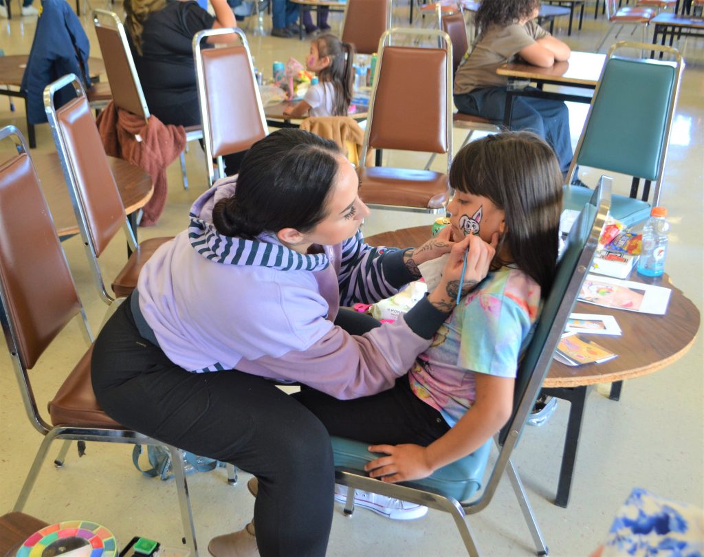 Facepainting at an Easter visiting event at Valley State Prison.