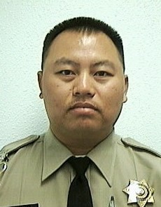Leu Saephan, correctional officer, wearing his uniform.