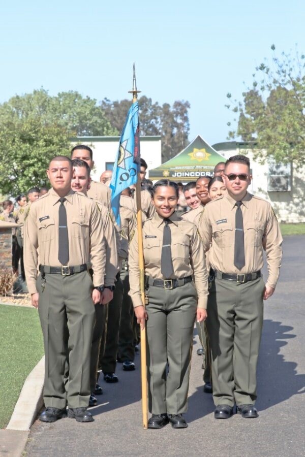 A group of correctional officer cadets prepare for graduation. 