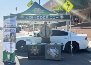 Calipatria State Prision employee at a Join CDCR booth during Law Day.