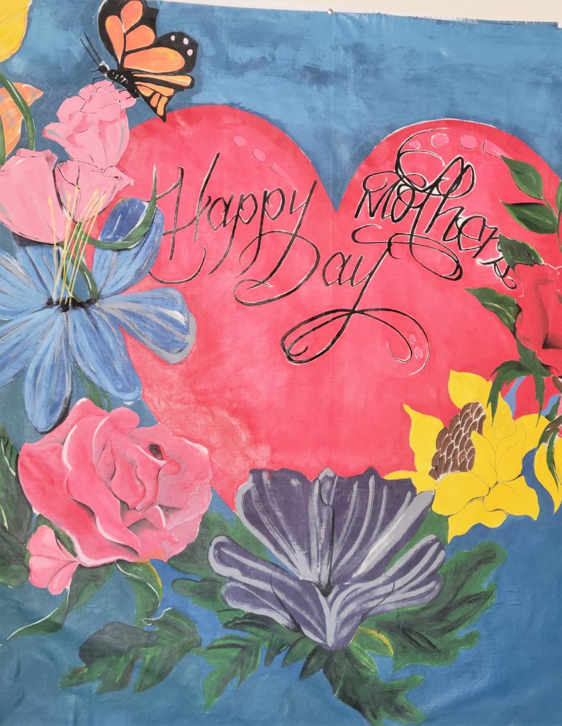 Happy Mother's Day painted backdrop at California Correctional Institution. 
