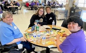 Central California Women's Facility Mother's Day with a family sitting at a table in the prison's visiting room.