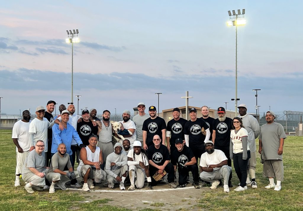 Group photo of volunteers on a baseball diamond at California Health Care Facility.