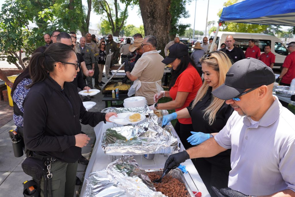 CIM manager serving food during staff appreciation day.