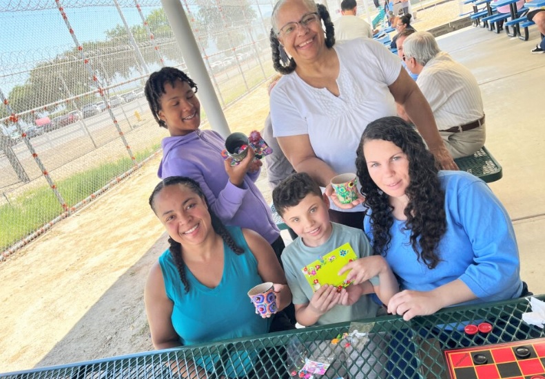 A group of kids and incarcerated mom at a California prison.