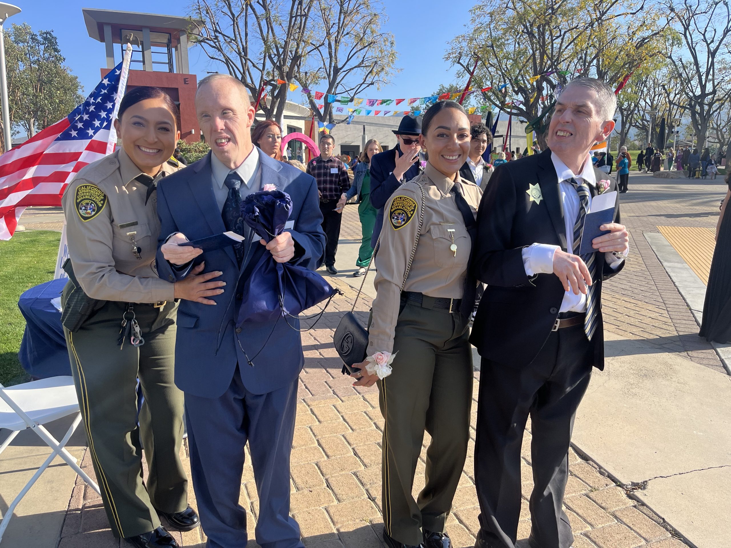 Two correctional officers with two special needs guests at a prom.