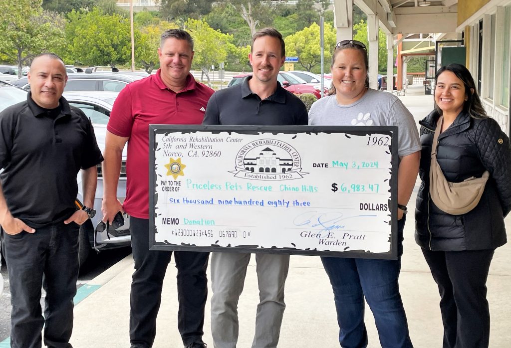 People hold an oversized donation check.