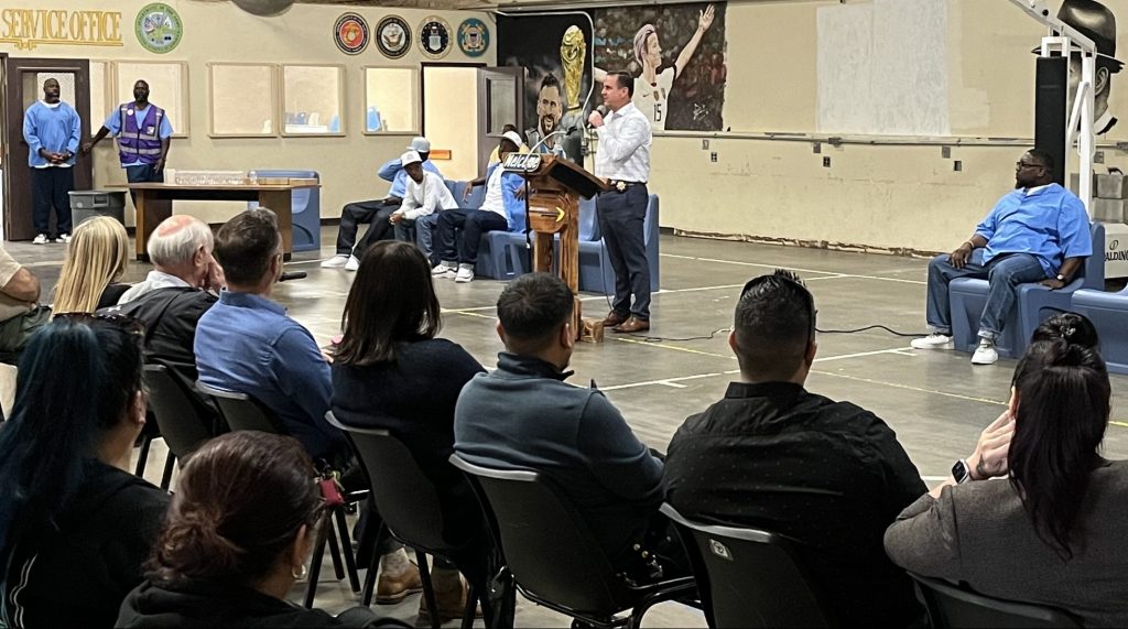 Prison warden speaks to a gathering.