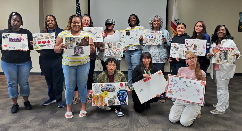 Parole participants hold vision boards. 