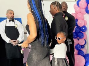 Male reentry program with a father, daughter and mother entering a dance event in Long Beach, California.
