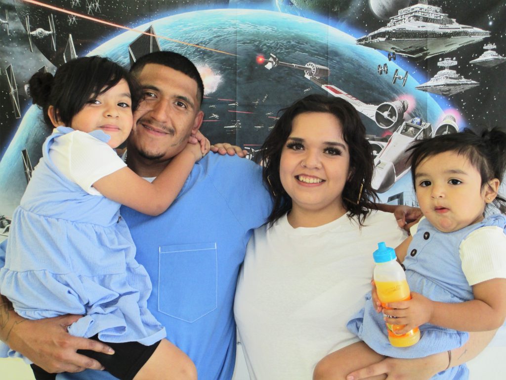 Star Wars themed visiting at Pleasant Valley State Prison with an incarcerated man holding a child and a woman holding an infant.