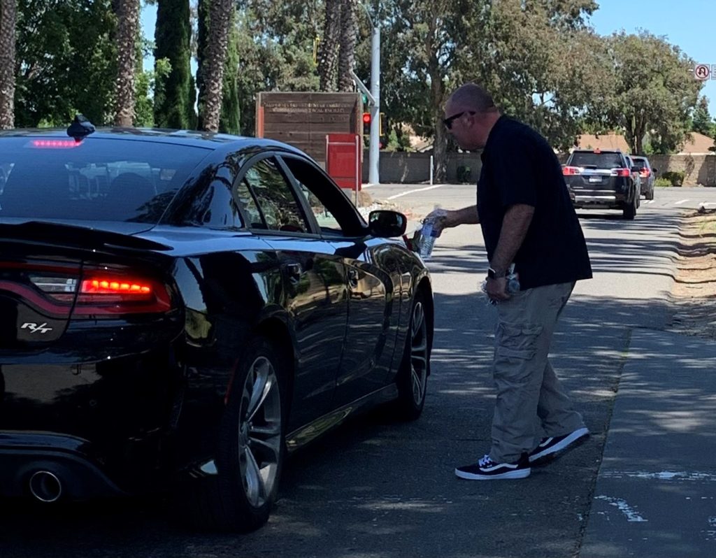 SOL management passing gift bag to officer