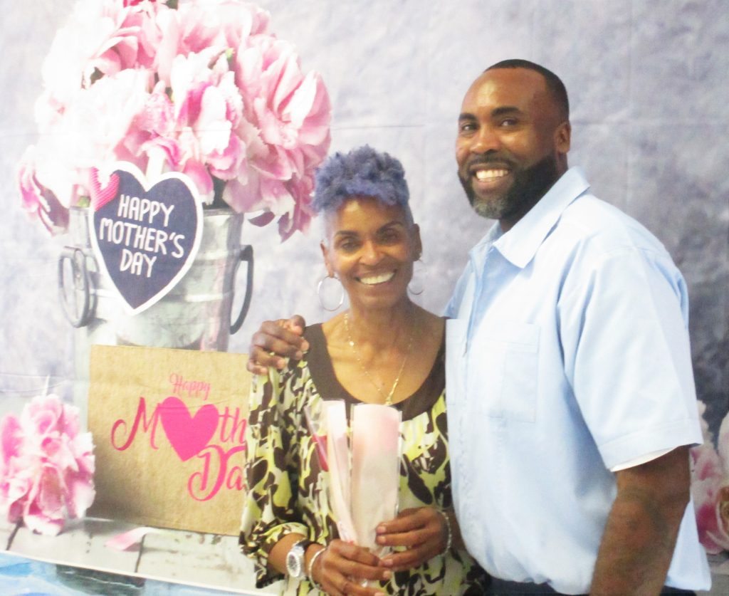 Mother's Day visiting with an incarcerated person and a woman holding a flower.