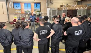 Academy students listen to a CDCR prison warden as they tour the facility.