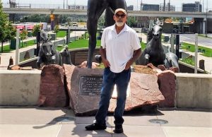 Anthony Salamanca with sculptures around him.