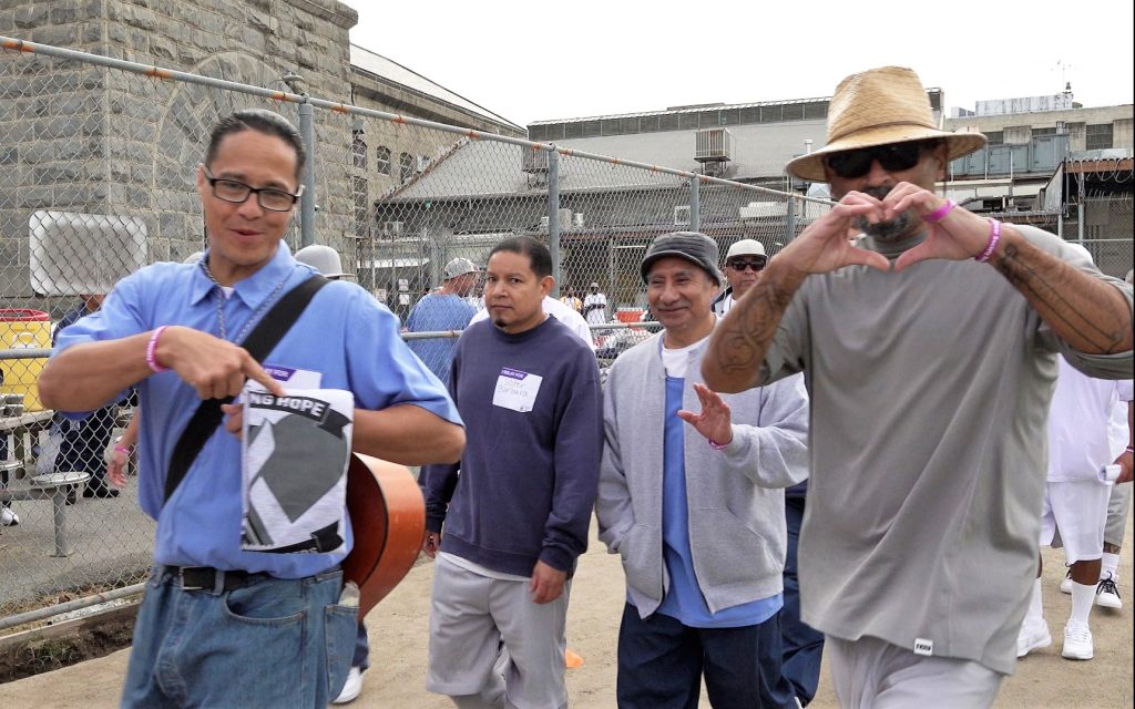 Incarcerated people walk around a track at Folsom State Prison.