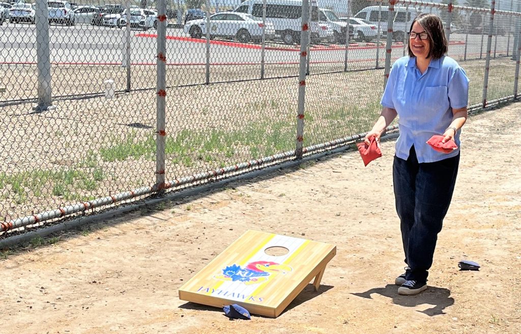 A woman plays corn hole during Father's Day visiting at California Institution for Women.