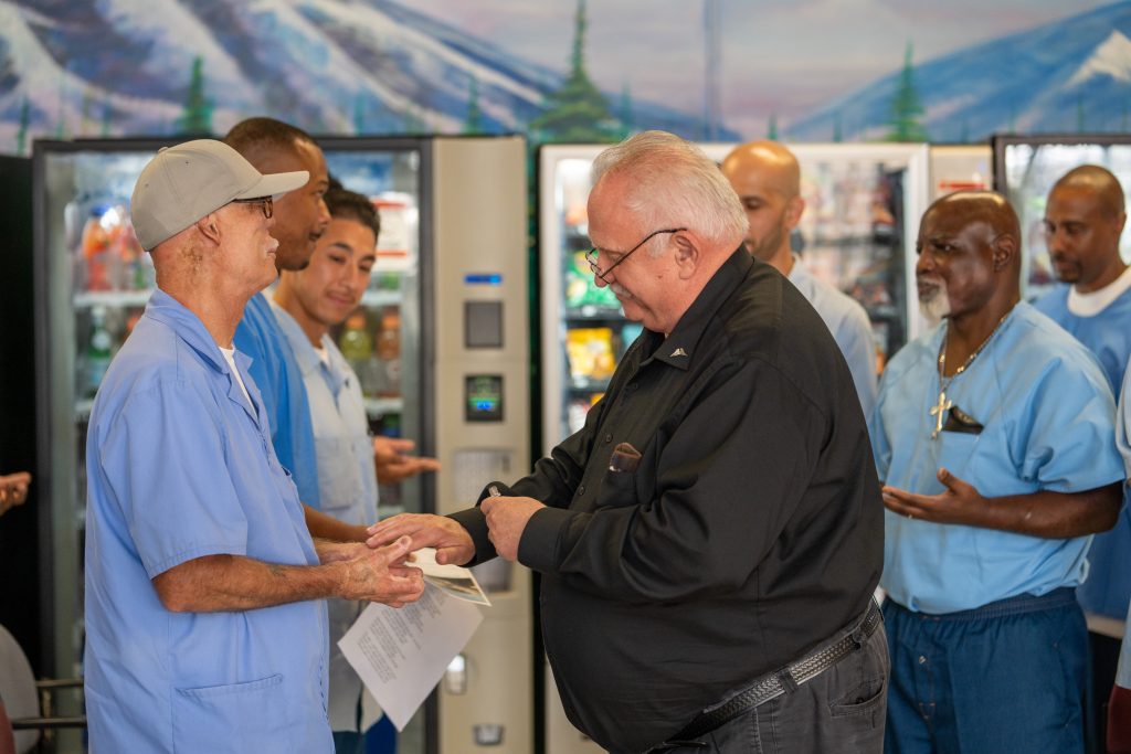 A chaplain blesses the graduates.