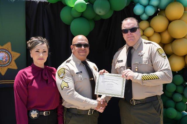 RJ Donovan promotion ceremony with the warden honoring a new sergeant.